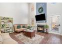 Cozy living room featuring a fireplace, comfortable seating, and ample natural light from large windows at 2709 Reid Meadows Dr, Charlotte, NC 28208