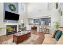 Bright living room with a fireplace, large TV, and open floor plan that connects to the kitchen at 2709 Reid Meadows Dr, Charlotte, NC 28208