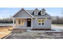 Close up of home featuring a covered porch and black front door at 4029 Miller Rd, Salisbury, NC 28147