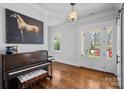 Welcoming entrance hall featuring hardwood floors, a grand piano, and natural light at 478 Beaty St, Davidson, NC 28036