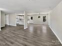 Bright and open living area, with sleek vinyl flooring and light-filled windows, flowing into a well-lit kitchen at 510 Newport Dr, Salisbury, NC 28144