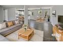Open-concept living room with modern gray sofa and dining area with updated flooring at 510 Newport Dr, Salisbury, NC 28144
