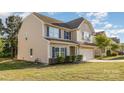 Charming beige two-story home with blue shutters, a side yard, and an attached garage at 532 Dalkeith Ave, Rock Hill, SC 29732