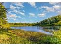 Scenic view of a tranquil pond surrounded by lush greenery and blue skies at 532 Dalkeith Ave, Rock Hill, SC 29732