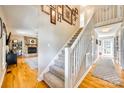 Bright entryway with wooden floors, leading to a living room and carpeted stairs at 6008 Lanai Ln, Tega Cay, SC 29708