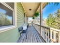 Inviting porch with wooden floors, bench seating, and relaxing outdoor space at 6008 Lanai Ln, Tega Cay, SC 29708