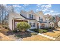 View of townhome units featuring brick and vinyl exterior and well-manicured lawns at 7361 Sun Dance Dr, Fort Mill, SC 29707