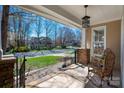 Cozy covered front porch with seating area offering a view of the neighborhood at 7806 Spanish Oaks Dr, Waxhaw, NC 28173