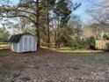 Backyard featuring a storage shed and ample space, perfect for outdoor activities and storage solutions at 8402 Albury Walk Ln, Charlotte, NC 28277