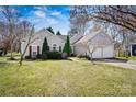 Charming one-story home with mature trees, manicured lawn, and an attached two-car garage at 8402 Albury Walk Ln, Charlotte, NC 28277