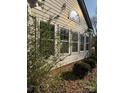 Home exterior showing large windows and brick foundation, enhancing its curb appeal and natural light at 8402 Albury Walk Ln, Charlotte, NC 28277