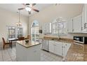 Bright kitchen featuring an island, granite counters, stainless appliances, and tile flooring at 8402 Albury Walk Ln, Charlotte, NC 28277