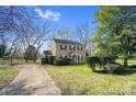 A view of the front yard of a two-story home showcasing its lawn and landscaping at 8501 Golf Ridge Dr, Charlotte, NC 28277