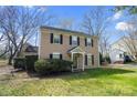 View of home featuring a traditional design with a well-maintained lawn and tidy landscaping at 8501 Golf Ridge Dr, Charlotte, NC 28277