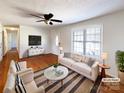 Bright living room with hardwood floors, neutral furniture, and plenty of natural light at 898 Sage Field Ln, Lincolnton, NC 28092