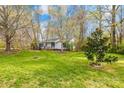 Lush lawn leads to home with mature trees and charming split-rail fence at 9136 Ladson Rd, Indian Land, SC 29707