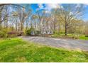 Well-manicured lawn leads to the house with a charming split-rail fence and mature trees at 9136 Ladson Rd, Indian Land, SC 29707