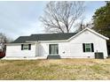 Home's rear exterior features a sliding glass door and a well-maintained lawn at 102 Guffey Rd, Cherryville, NC 28021