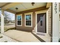 Cozy covered front porch features traditional decor, windows, and a welcoming front door at 11203 Chapeclane Rd, Charlotte, NC 28278