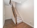 Inviting entryway with hardwood floors, a carpeted staircase, and decorative iron railings at 11679 Red Rust Ln, Charlotte, NC 28277