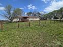 Expansive backyard with lush greenery, mature trees, wooden fence, and a relaxing deck at 117 Jones Rd, Shelby, NC 28150