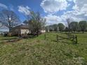 Spacious backyard featuring mature trees, fencing, and a deck, perfect for outdoor activities and entertaining at 117 Jones Rd, Shelby, NC 28150