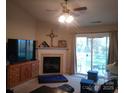 Inviting living room features a fireplace, ceiling fan, and sliding glass doors to outdoor space at 11910 Lorden Ave, Charlotte, NC 28213