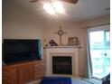 Inviting living room features a fireplace, ceiling fan, and sliding glass doors to outdoor space at 11910 Lorden Ave, Charlotte, NC 28213
