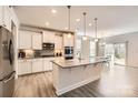 Modern kitchen features stainless steel appliances, granite countertops, and a central island at 120 Hornbeam Ln, Mooresville, NC 28117