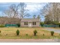 Inviting single-story house with a spacious front yard, complemented by green landscaping and a cozy appeal at 1216 Center St, Wadesboro, NC 28170