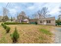 Serene property showcasing a well-maintained lawn, lush greenery, and a cozy single-story home at 1216 Center St, Wadesboro, NC 28170