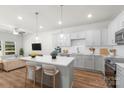 Bright, open-concept kitchen with a quartz island, stylish pendant lights, and stainless steel appliances at 1322 Condon St, Charlotte, NC 28216