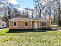 Cozy one-story home with a well-maintained lawn and a traditional facade offering a comfortable living space at 1327 Santee St, Charlotte, NC 28208