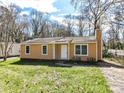 Single-story home with a neatly manicured lawn and a simple yet elegant exterior, offering a welcoming ambiance at 1327 Santee St, Charlotte, NC 28208
