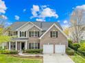 Beautiful two-story brick home features a two-car garage and well-maintained landscaping at 13514 Porter Creek Rd, Charlotte, NC 28262