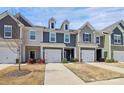 Street view of modern townhomes with individual garages and landscaped yards at 2707 Aubrey St, Monroe, NC 28110