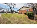 View of a corner lot home with a well-kept lawn and established neighborhood at 3000 Dalecrest Dr, Charlotte, NC 28269