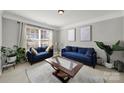 Bright living room featuring stylish blue sofas, neutral walls and large windows with natural lighting, offering a cozy space at 311 Glenn Allen Rd, Mooresville, NC 28115