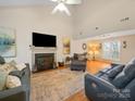 Spacious living room featuring a fireplace, entertainment center, and comfortable seating arrangement at 3229 Leicester Dr, Matthews, NC 28104