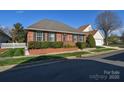 Beautiful single-story brick house with tidy landscaping and inviting curb appeal at 3913 Sages Ave, Indian Trail, NC 28079