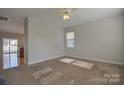 Bright living room with neutral carpet, ceiling fan, and ample natural light at 3913 Sages Ave, Indian Trail, NC 28079