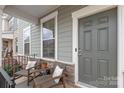 Inviting front porch with seating offers a cozy spot to relax outdoors at 4102 Harmony Hills Dr, Matthews, NC 28104
