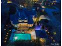 Aerial view of a luxurious estate with a pool, spa, manicured grounds, and outdoor living spaces at 4510 Old Course Dr, Charlotte, NC 28277