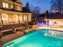 Beautiful backyard with a sparkling pool, spa, and covered outdoor dining area at 4510 Old Course Dr, Charlotte, NC 28277