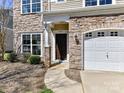 Charming home exterior with stone accents, a front yard, and an attached garage at 4634 Craigmoss Ln, Charlotte, NC 28278