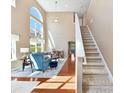 Open-concept living room boasts hardwood floors, fireplace, and staircase at 4634 Craigmoss Ln, Charlotte, NC 28278