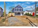 Newly built two-story home with blue siding, showcasing its front yard and overall structure at 513 Harrel St, Salisbury, NC 28144