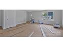 Bright living room with fresh white walls, natural light from the window, and door at 513 Harrel St, Salisbury, NC 28144