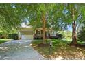 Lovely home featuring a spacious front lawn with mature trees, and a welcoming front porch at 8008 Battersea Ct, Waxhaw, NC 28173