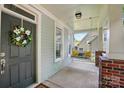 Inviting front porch with a porch swing, brick accents, and a decorative wreath on the front door at 8008 Battersea Ct, Waxhaw, NC 28173